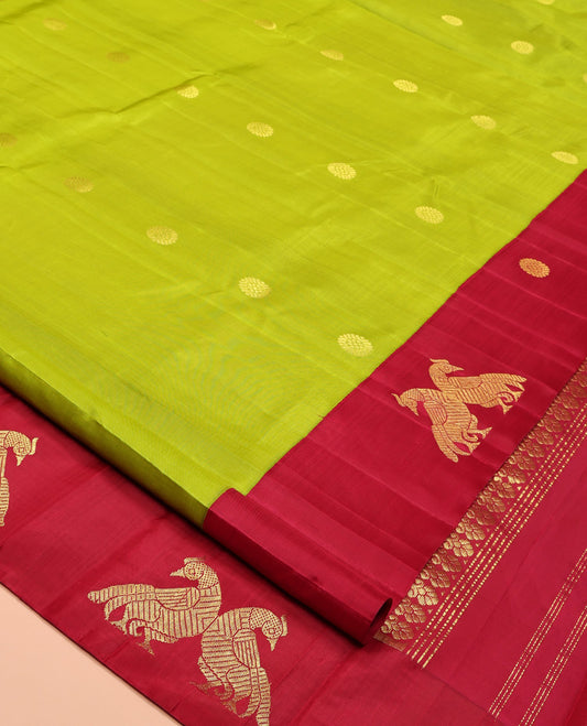 Green Kanchipuram Silk Saree, Styled with Chakram Buttas, Complemented by a Contrast One-Sided Korvai Border of Mayil and Chakram Designs, Pallu Steeped with Mayil Designs, and No Blouse
