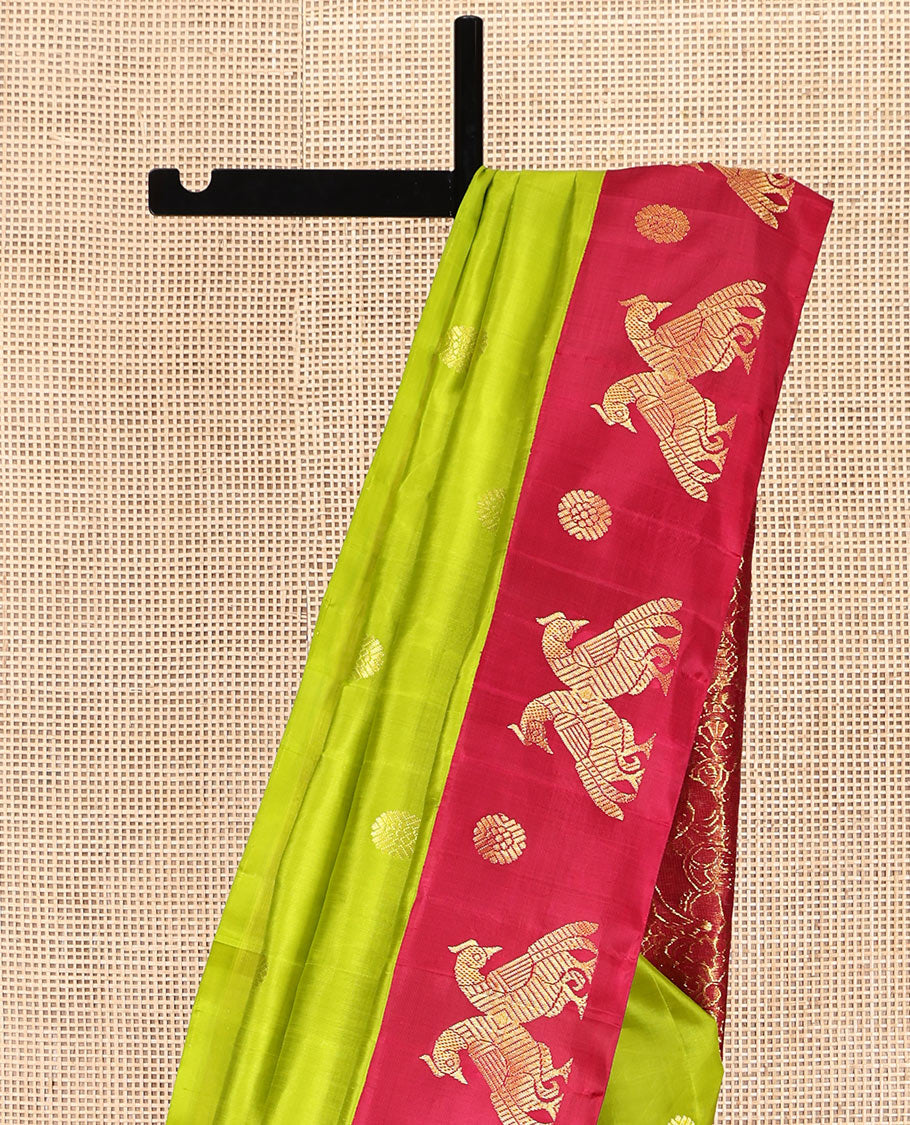 Green Kanchipuram Silk Saree, Styled with Chakram Buttas, Complemented by a Contrast One-Sided Korvai Border of Mayil and Chakram Designs, Pallu Steeped with Mayil Designs, and No Blouse