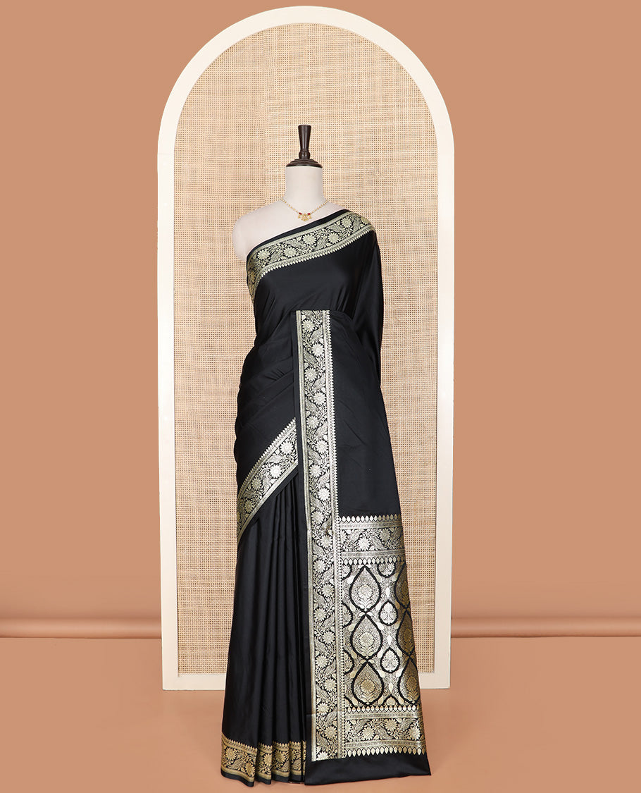 Inky Black Semi-Banaras Satin Saree, Subtly Sparkled Border of Floral Creeper Designs, Pallu Beautified with Thilak Motifs in Zari, and Paired with a Matching Blouse