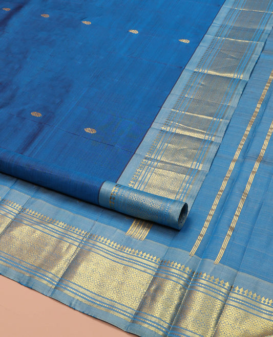 Blue Kanchipuram Silk Saree, Beautified with Zari Buttas on Its Body, Complemented by a Contrast One-Sided Border of Panner Sombu, Banaras, Muthu, and Jaal Designs, Pallu Depicts Zari Designs, and Comes Without a Blouse