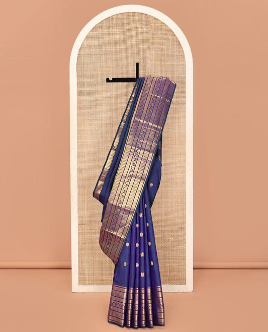 Blue Kanchipuram Silk Saree, Embellished with Mayil and Chakram Buttas All Over Its Body, Highlighted by a Zari Border of Traditional Designs, Pallu Steeped with Traditional Designs, and Paried with a Matching Blouse