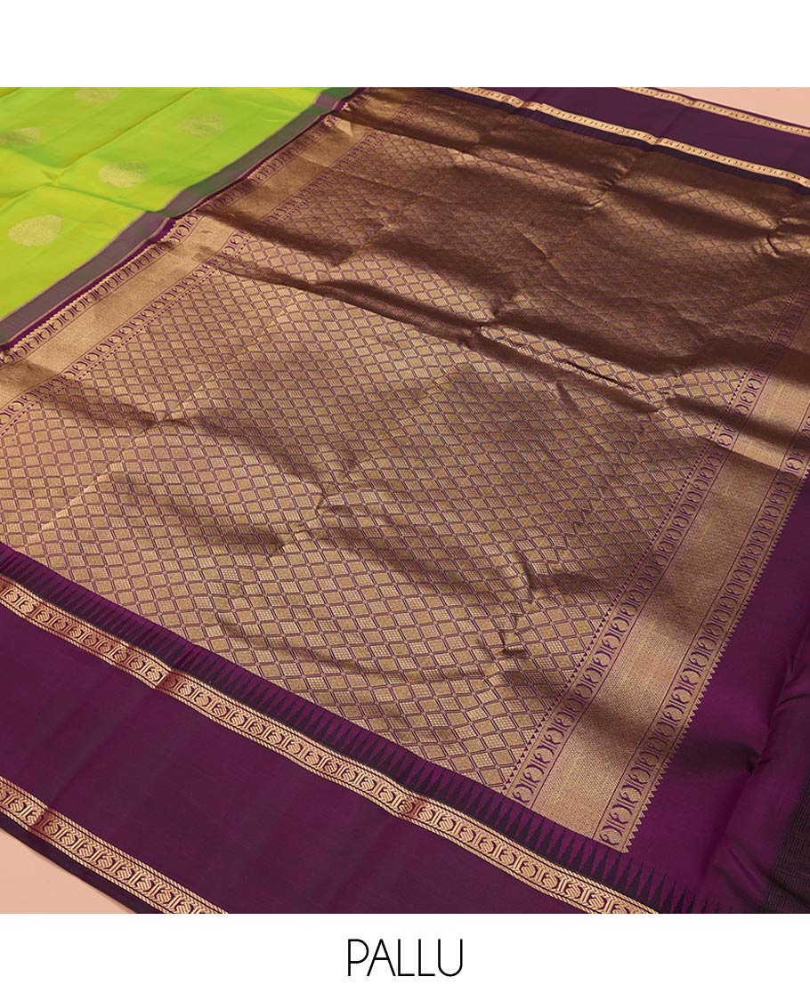 Green Vasundhara Silk Saree, Delicately Woven with Zari Buttas All Over Its Body, Complemented by a Contrast Rettai Pettu Temple Border of Banaras, and Manga Designs, Grand Jaal Pallu, and Paired with a Contrast Blouse