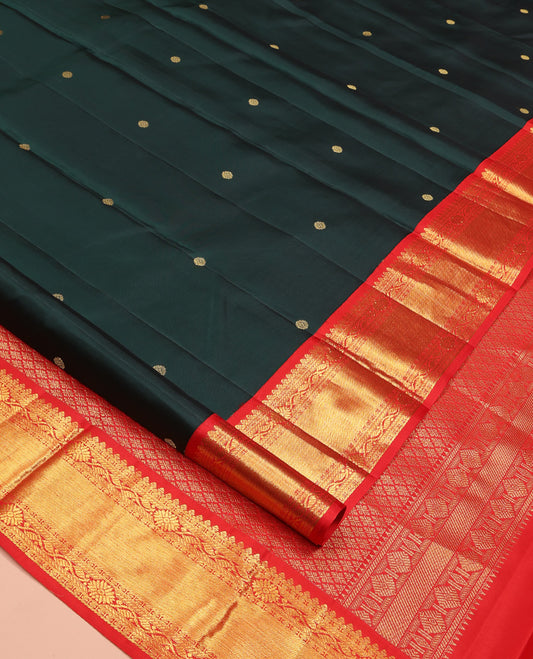 Dark Green Vasundhara Silk Saree, Spotlighted with Zari Buttas All Over Its Body, Complemented by Contrast Border of Traditional Zari Designs Grand Jaal Pallu and Paired with a Contrast Blouse