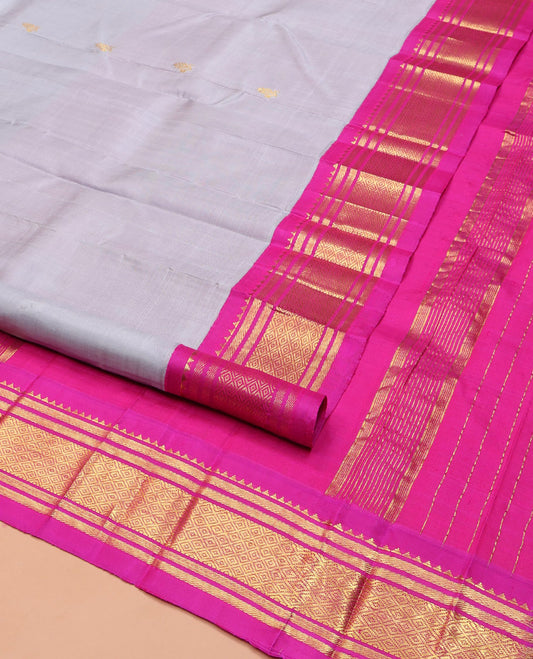 Grey Kanchipuram Silk Saree, Enthralled with Zari Buttas on Its Body, Complemented by a Contrast One-Sided Korvai Border of Rekku, Banaras, and Mayil Kann Designs, Pallu Steeped with Zari Designs, and Comes Without a Blouse