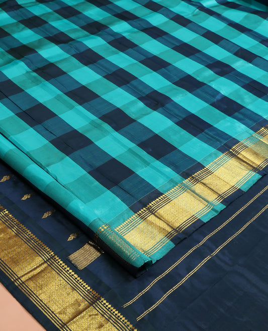 Blue Checked Kanchipuram Silk Saree, a Zari One-sided Border of Paneer Sombu, Banaras, Muthu, and Mayil Kann Designs, Pallu of Zari Designs, and No Blouse