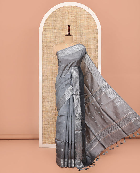 Grey Banana Pith Saree, Subtly Sparkled with Buttas All Over Its Body, Highlighted by Self-Border of Temple and Rudraksham Motifs, Pallu Steeped with Stripes and Buttas, and Paired with a Matching Blouse