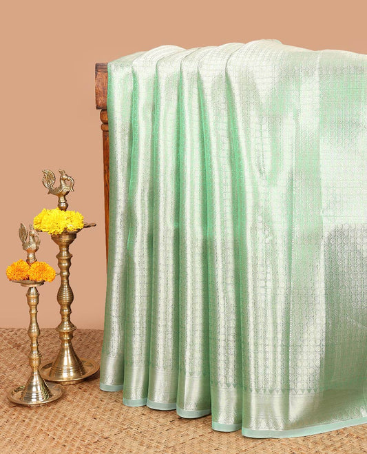 Green brocade design celebrity tissue saree with self border & rich pallu along with plain blouse
