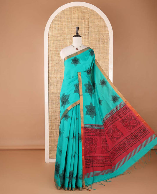 Blue six-petal-like leaf motifs printed micro-silk saree, copper zari border, contrast intricate pallu & plain blouse