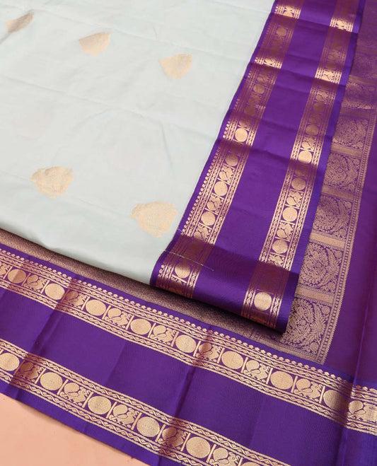 Pale Blue Vasundhara Lite Silk Mix Saree, Enriched with Zari Buttas All Over Its Body, Complemented by Contrast Korvai Border of Thilakam Mokku, Neli, Mayil, and Poun Designs, Gleaming Zari Decked Up Pallu, and Paired with a Contrast Blouse