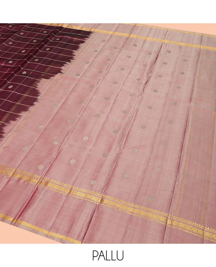 Maroon Kanchipuram Silk Saree, Richly Detailed with Chakram Buttas Enclosed Checks, Complemented by a Contrast Rettai Pettu Border of Rekku, Banaras, Muthu, and Poun Designs, Pallu Steeped with Chakram Motifs, and Paired with a Contrast Blouse