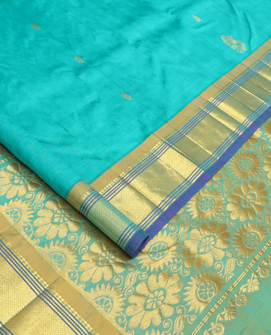 Blue zari buttas Kanchipuram silk saree, contrast border of paneer sombu, banaras, muthu, and mayil kann designs, and floral design pallu