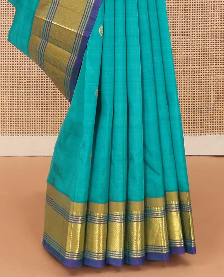 Blue zari buttas Kanchipuram silk saree, contrast border of paneer sombu, banaras, muthu, and mayil kann designs, and floral design pallu