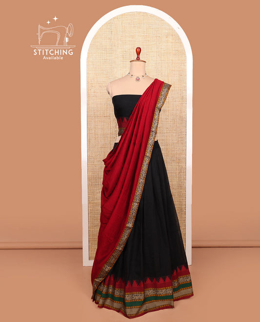 Black plain cotton half-saree with contrast temple traditional zari bordered skirt, a matching blouse, and a contrast traditional bordered dhavani