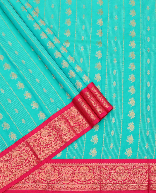 Light Turquoise Art Silk Pavadai Material Set, Graced with Zari Design on Its Skirt, Complemented by a Contrast Zari Design Border, and Paired with a Contrast Blouse