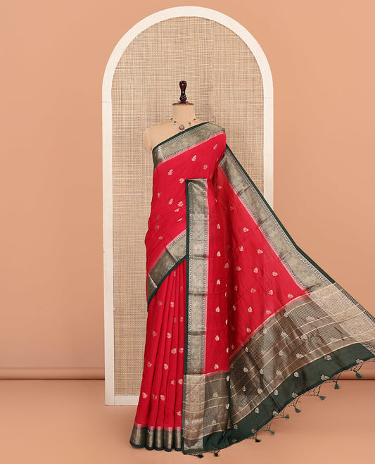 Red Assam Silk Saree Gracefully Embellished with Floral Zari Buttas, Complemented by Captivating Contrast Border Featuring Traditional Zari Designs, Gleaming Pallu of Zari Designs, and Paired with a Contrast Blouse