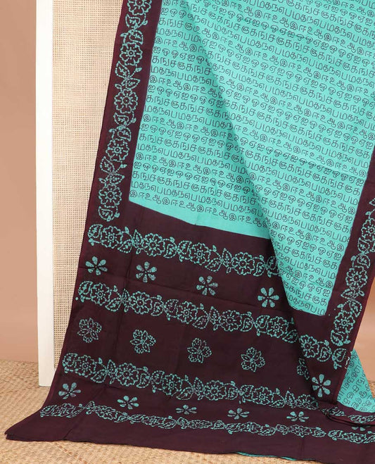 Turquoise Tamil letters printed sungudi cotton saree, contrast batik printed border, and batik printed pallu