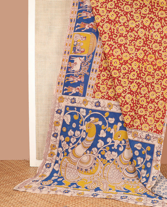 Red batik floral machine-printed cotton saree, contrast village-theme printed border, and pallu of Kalamkari peacocks