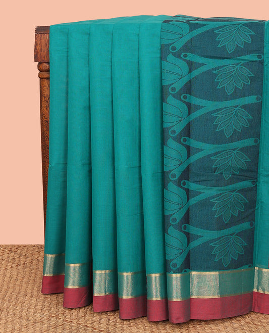 Blue Kanchi Cotton Saree, Decorated with Buttas All Over Its Body, Complemented by a Contrast Border, Pallu Features Floral Designs, and Paired with a Matching Blouse