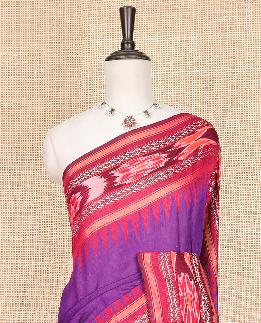 Purple Plain Dupion Silk Saree, Spotlighted with a Contrast Temple Border of Geometric Patterns and Ikkat Weave, Pallu Depicting Floral Ikkat Designs, and Paired with a Contrast Blouse
