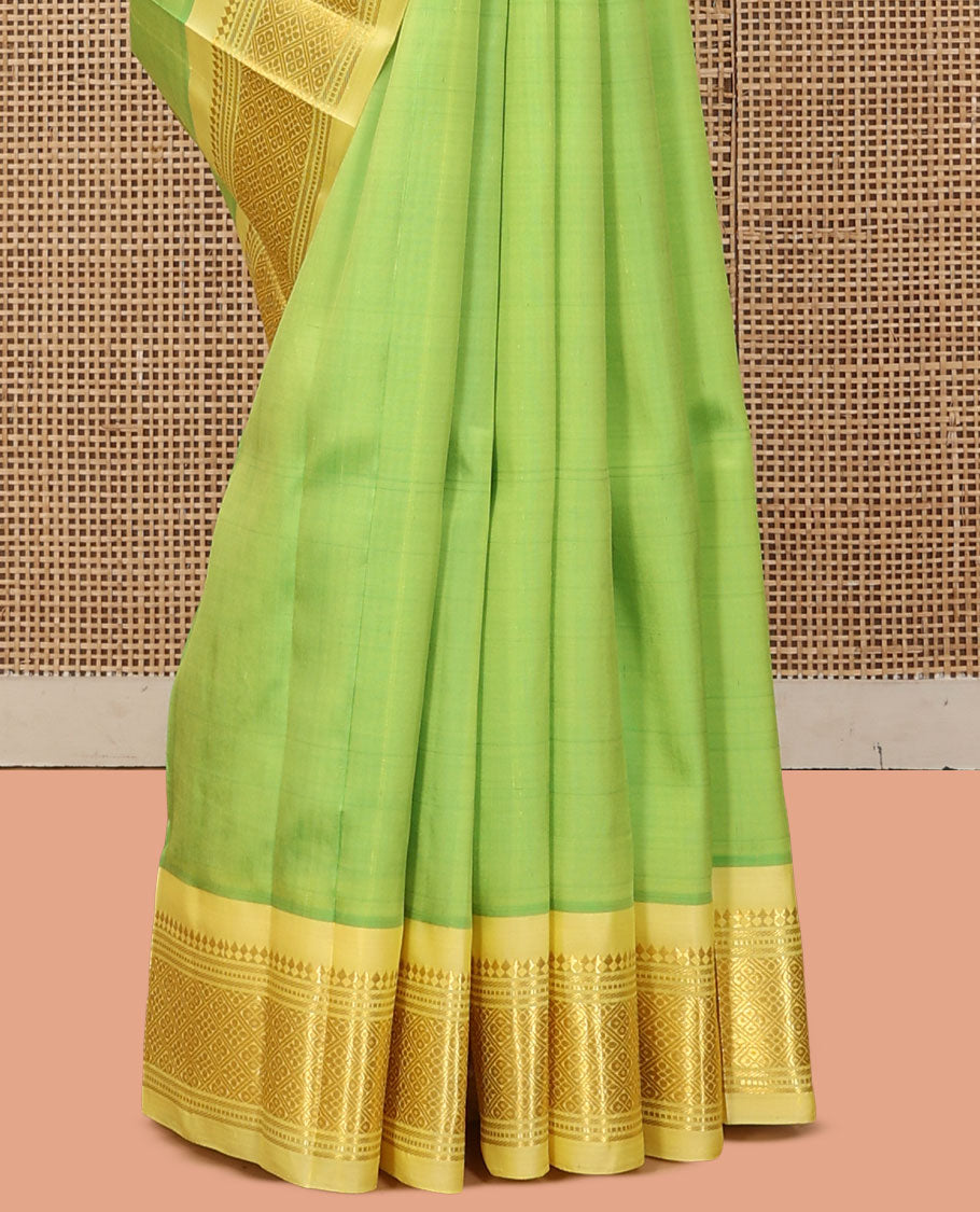 Green Kanchipuram Silk Saree, Woven with Zari Buttas, a Contrast One-Sided Border of Panner Sombu, Banaras, Muthu, and Jaal Designs, a Zari Design Pallu, and No Blouse