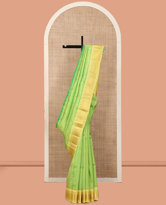 Green Kanchipuram Silk Saree, Woven with Zari Buttas, a Contrast One-Sided Border of Panner Sombu, Banaras, Muthu, and Jaal Designs, a Zari Design Pallu, and No Blouse