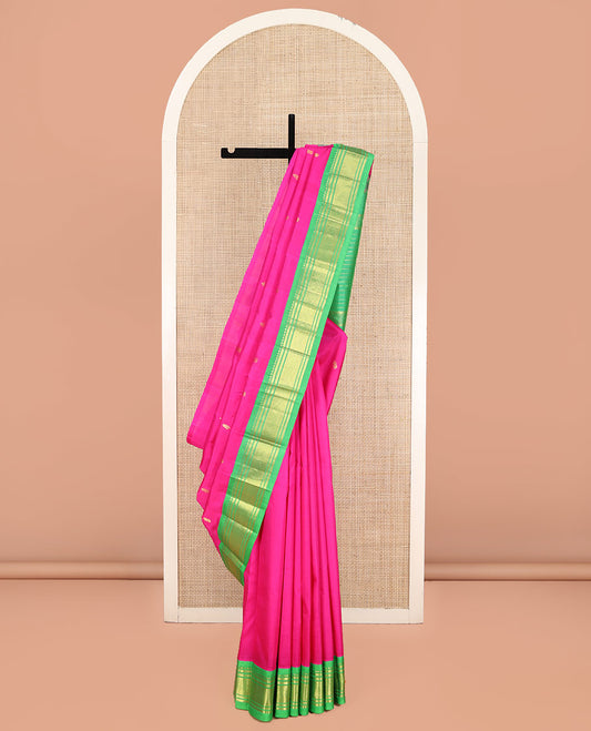 Pink Kanchipuram Silk Saree, Spotlighted with Zari Buttas on Its Body, Complemented by a Contrast One-Sided Korvai Border of Rekku, Banaras, and Mayil Kann Designs, Pallu Steeped with Zari Designs, and Comes Without a Blouse