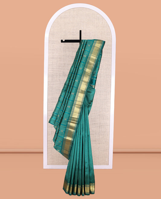Green Kanchipuram Silk Saree, Subtly Sparkled with Stripes and Buttas, a Zari One-sided Border of Paneer Sombu, Banaras, Muthu, and Jaal Designs, Zari Design Pallu, and No Blouse