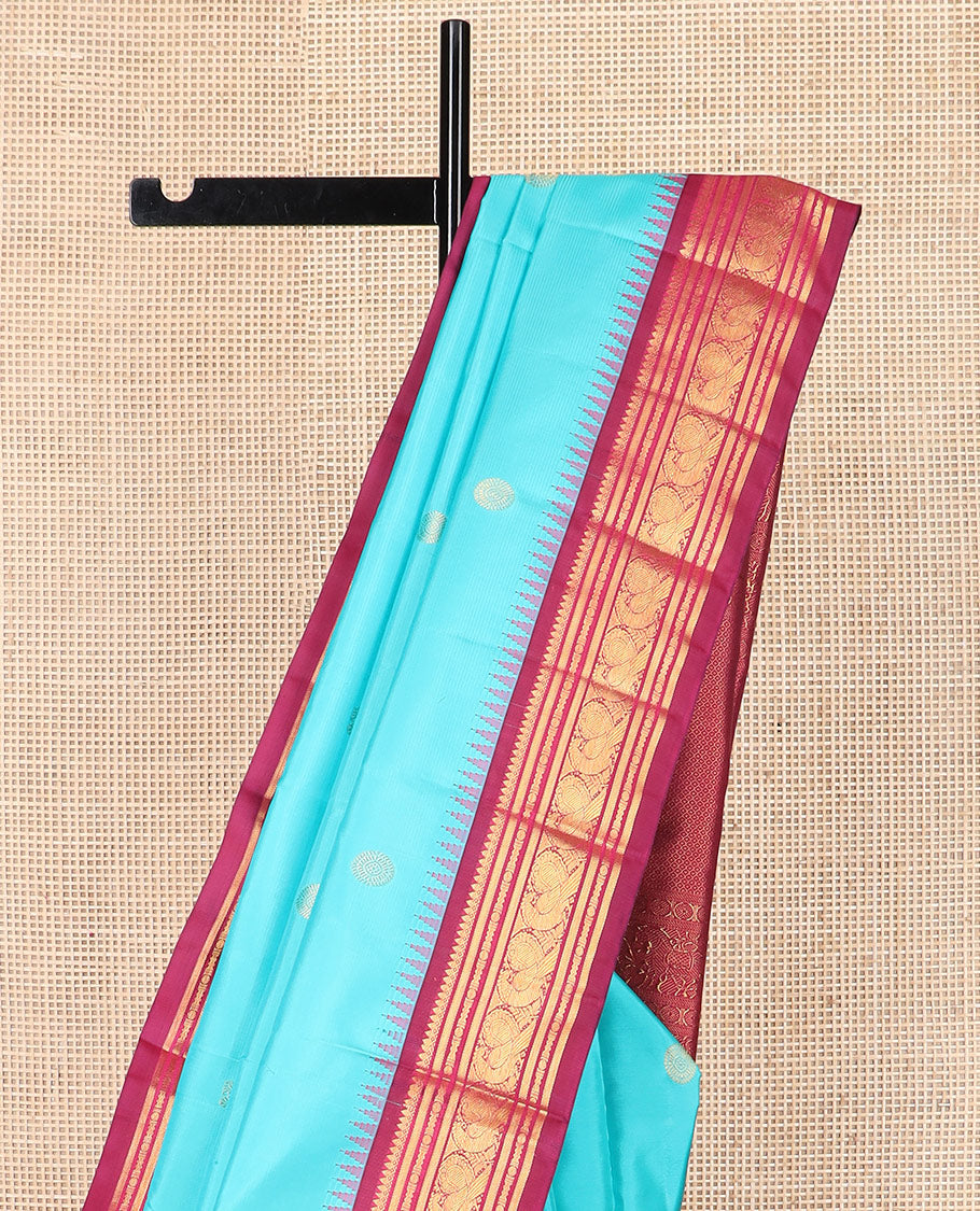 Blue mayil chakram buttas Kanchipuram silk saree, contrast thazampoo rekku border of thilakam mokku, banaras, rudraksham, and mayil designs, and intricate pallu