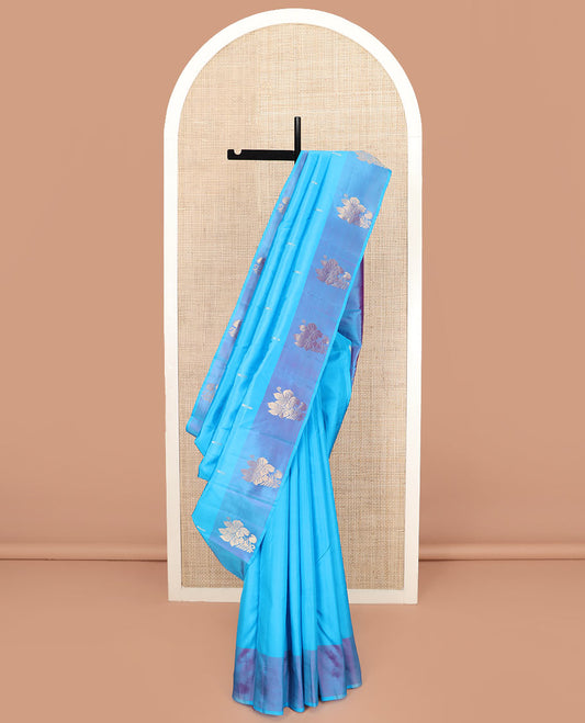 Blue Kanchipuram Silk Saree Featuring Zari Buttas, Complemented by a Contrast Border of Floral Motifs, a Subtle Pallu Woven with Floral Zari Designs, and Paired with a Contrast Blouse