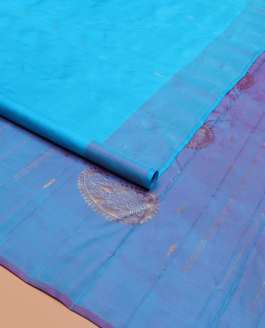 Blue Kanchipuram Silk Saree Featuring Zari Buttas, Complemented by a Contrast Border of Floral Motifs, a Subtle Pallu Woven with Floral Zari Designs, and Paired with a Contrast Blouse