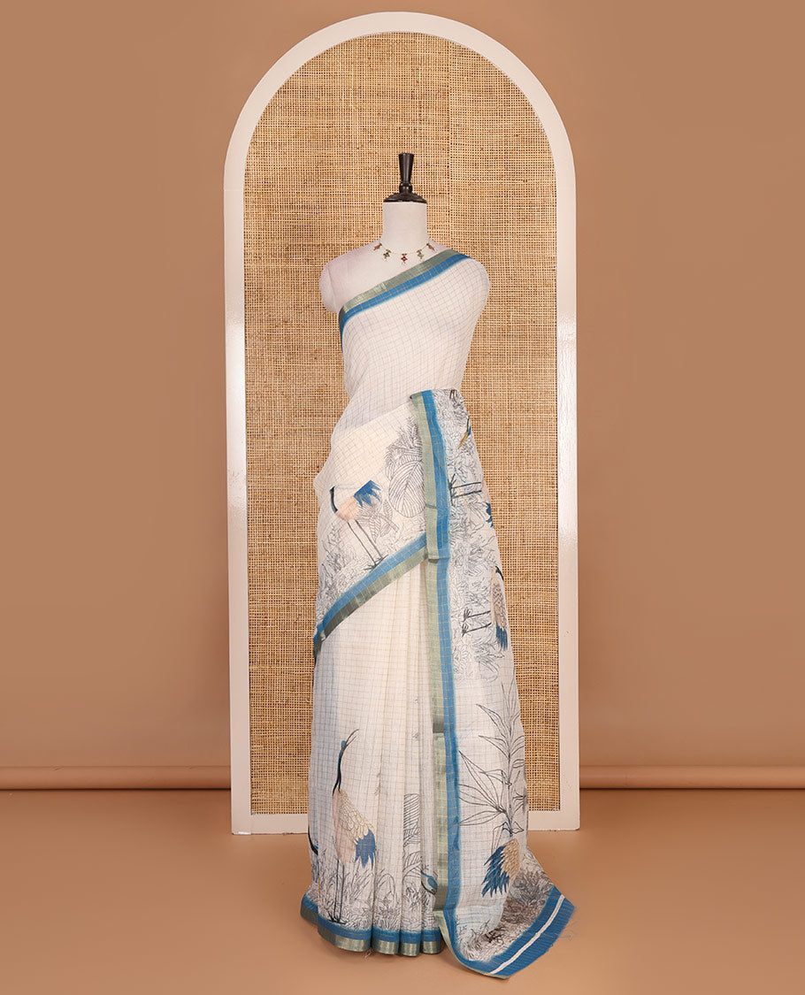 White with blue zari checks linen saree with contrast border and unique designs of pallu along with contrast plain blouse