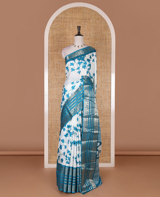 Blue leaf motifs printed dola silk saree, contrast traditional zari border of Rudraksham and peacock motifs, geometric printed pallu and contrast printed blouse