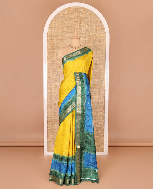 Yellow buttas enclosed checked dola silk saree, contrast shibori print with traditional zari border, buttas enclosed checked pallu, and a contrast buttas enclosed checked blouse