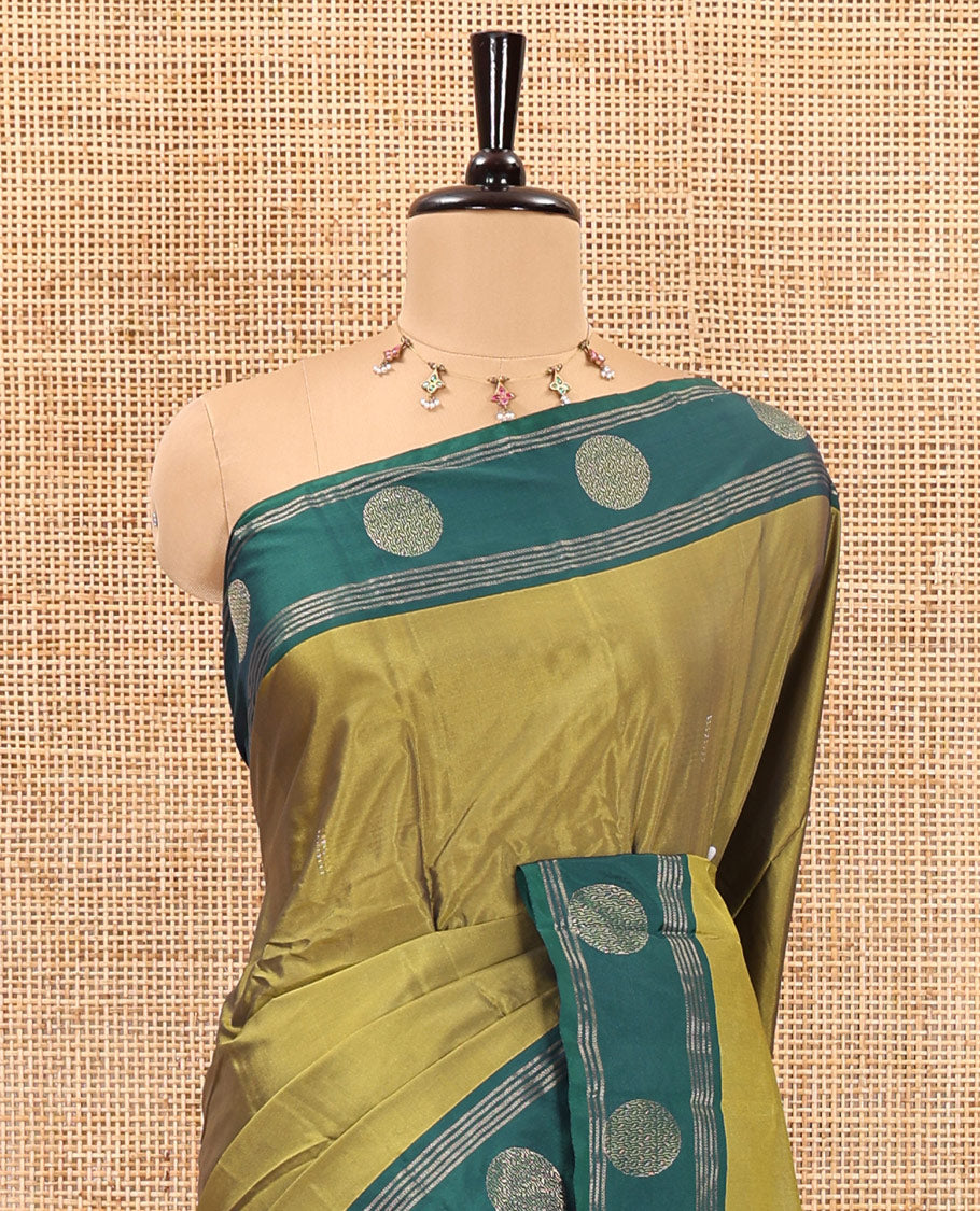 Green dobby style buttas semi-soft silk saree, contrast round buttas and striped border, striped pallu, and a plain blouse