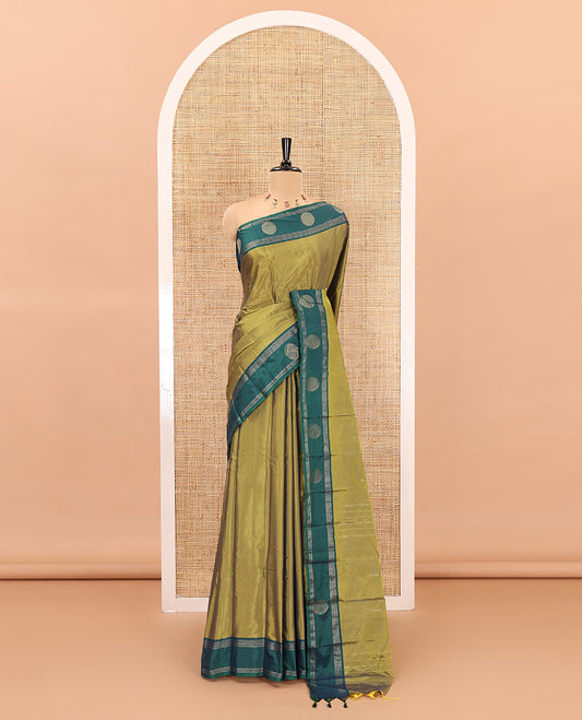 Green dobby style buttas semi-soft silk saree, contrast round buttas and striped border, striped pallu, and a plain blouse