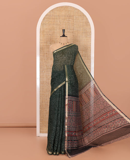 Green bandhani-style floral and chakra printed saree, zari piping border, contrast ajrakh printed pallu, and contrast ajrakh printed blouse