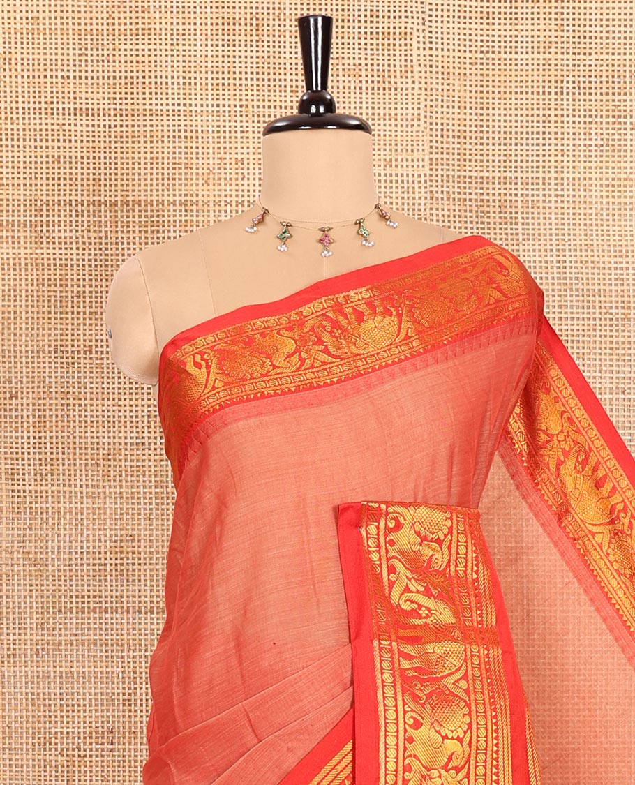 Light Rust Orange Plain Mercerised Cotton Saree Highlighted with a Contrasting Rettai Pettu Border Featuring Peacock and Elephant Motifs in Zari, a Subtly Striped Pallu, and a Matching Blouse