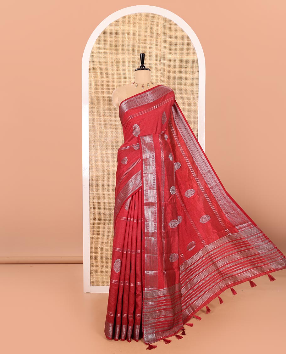 Maroon Semi-Tussar Saree Beautified with Gold Zari Stripes and Elegant Paisley Zari Buttas, Featuring a Subtly Shimmering Pallu Adorned with Traditional Zari Designs, and Paired with a Matching Blouse
