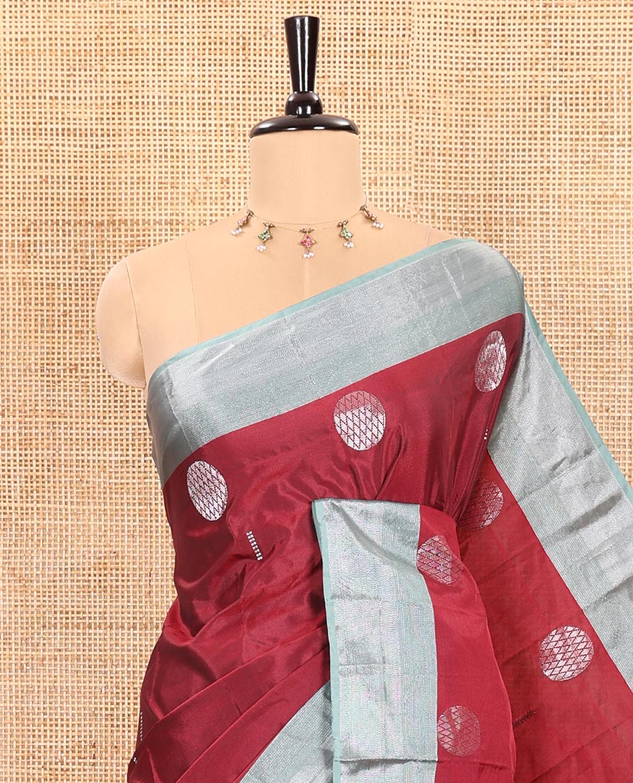 Cherry Red Semi-Soft Silk Saree Featuring Round Silver Zari Buttas Woven Across Its Body, Complemented by a Contrast Zari Design Border, Subtly Made Self-Pallu, and a Matching Blouse