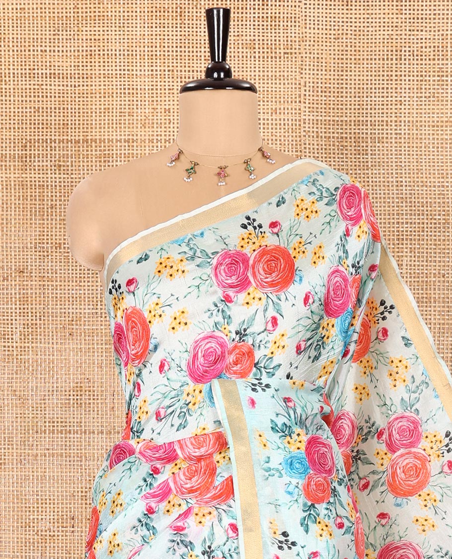 Sky Blue Banana Pith Saree Prettified with Multi-Color Rose Floral Motifs Print, Subtle Small Bavanji Border, Pallu Steeped with Zari Stripes, and Complemented with a Contrast Floral-Printed Blouse