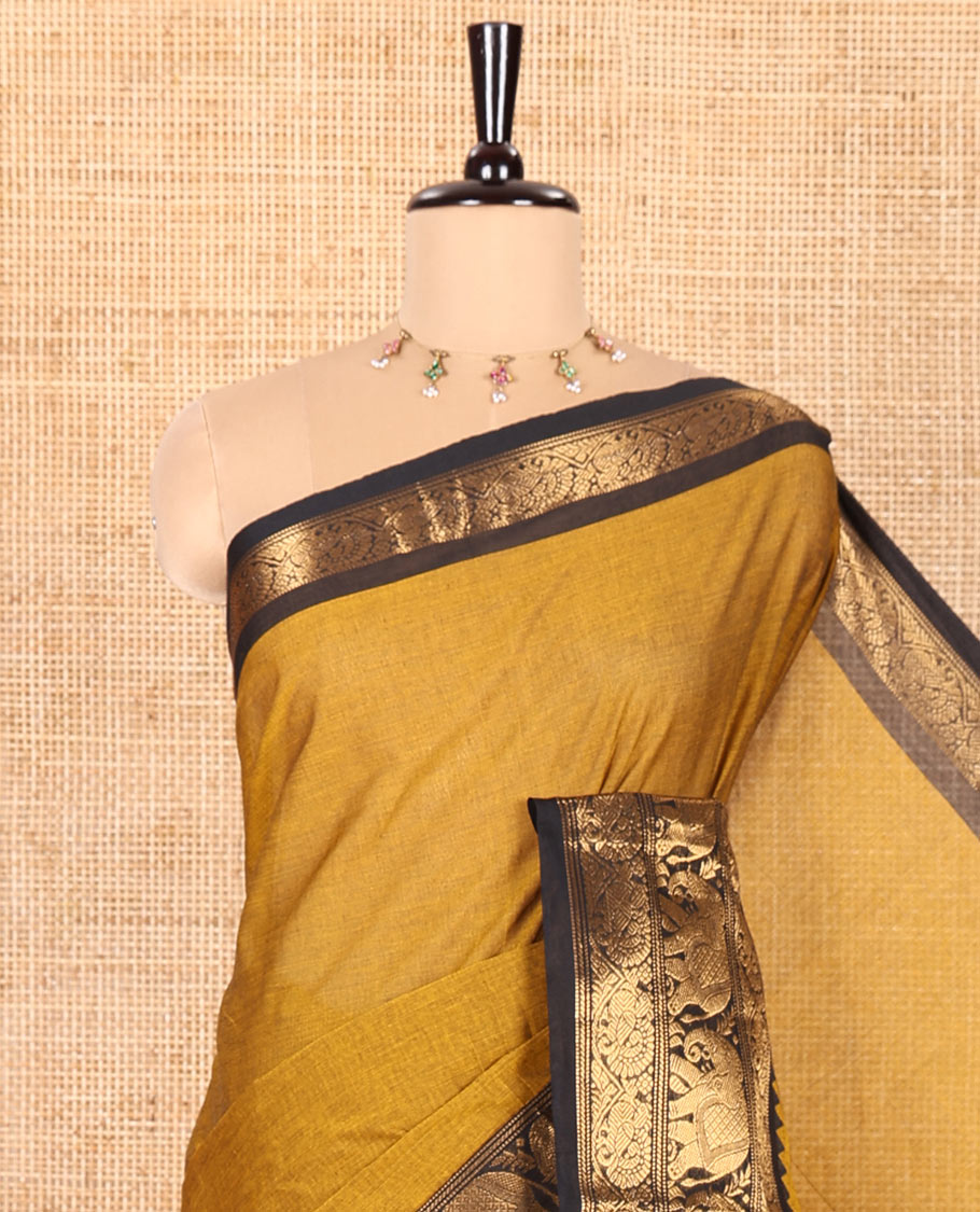 Gold Plain Chettinad Cotton Saree, Complemented by Contrast Temple Traditional Zari Border of Peacock and Elephant Designs, Subtly Striped Pallu, and Paired with a Matching Blouse