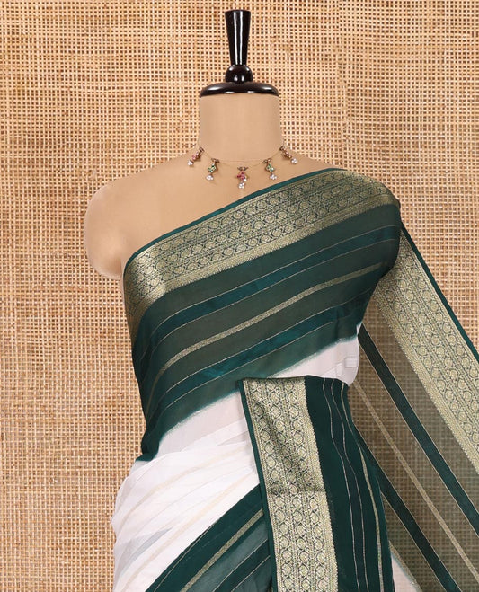 White and Green Georgette Saree, Subtly Sparkled with Horizontal Zari Stripes All Over Its Body, Complemented by a Contrast Traditional Zari Design Border, Gleaming Zari Striped Pallu, and Paired with a Contrast Blouse