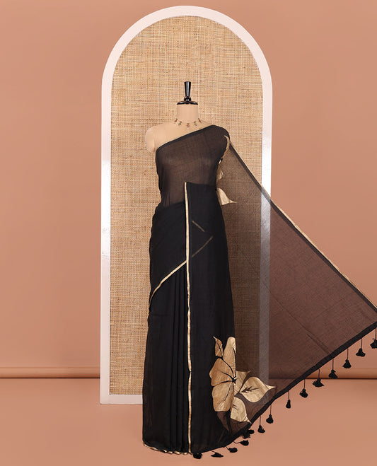 Borderless Black Khadi Mul Cotton Saree, Prettified with Big Hibiscus Floral Motifs Foil-Printed on Its Body, Subtly Sparkled Pallu of the Same Print and Tassels, and Paired with a Matching Blouse