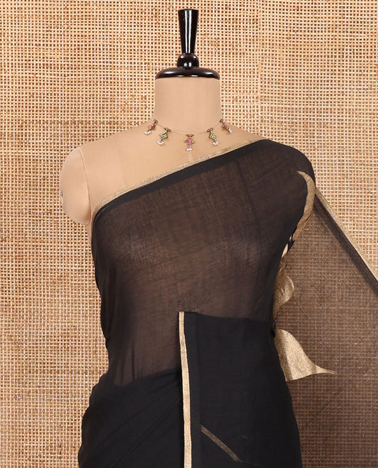 Borderless Black Khadi Mul Cotton Saree, Prettified with Big Hibiscus Floral Motifs Foil-Printed on Its Body, Subtly Sparkled Pallu of the Same Print and Tassels, and Paired with a Matching Blouse