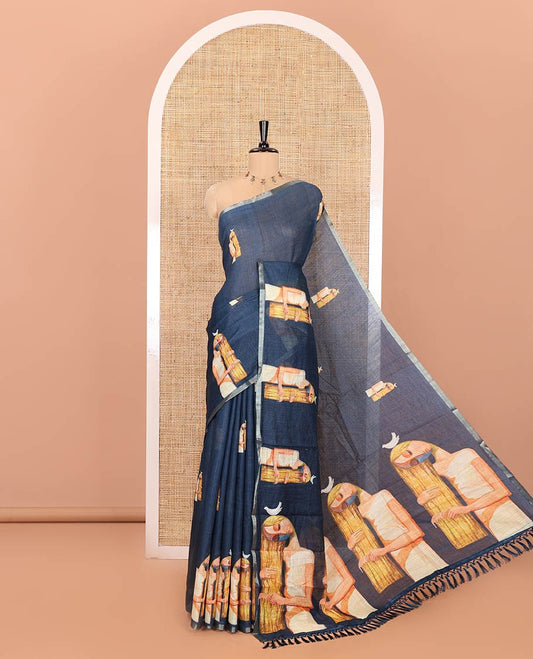 Blue Linen Saree, Decorated with Woman Braiding Her Hair Motifs Printed on Its Body, Subtle Zari Piping Border, Pallu Mirrors the Same Print, and Comes with a Matching Printed Blouse