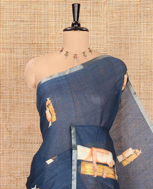 Blue Linen Saree, Decorated with Woman Braiding Her Hair Motifs Printed on Its Body, Subtle Zari Piping Border, Pallu Mirrors the Same Print, and Comes with a Matching Printed Blouse