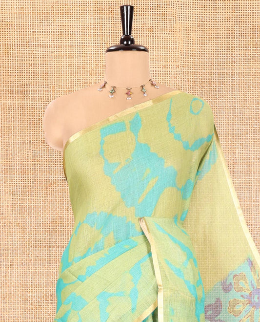 Light Green Linen Cotton Saree, Accentuated with Shibori Printed on Its Body, Subtle Piping Border, Pallu Features Floral Print, and Paired with a Contrast Floral Printed Blouse