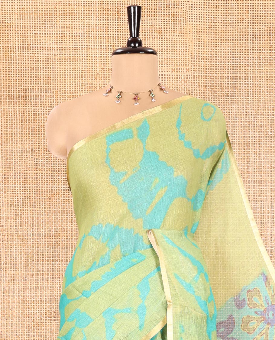 Light Green Linen Cotton Saree, Accentuated with Shibori Printed on Its Body, Subtle Piping Border, Pallu Features Floral Print, and Paired with a Contrast Floral Printed Blouse