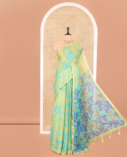 Light Green Linen Cotton Saree, Accentuated with Shibori Printed on Its Body, Subtle Piping Border, Pallu Features Floral Print, and Paired with a Contrast Floral Printed Blouse