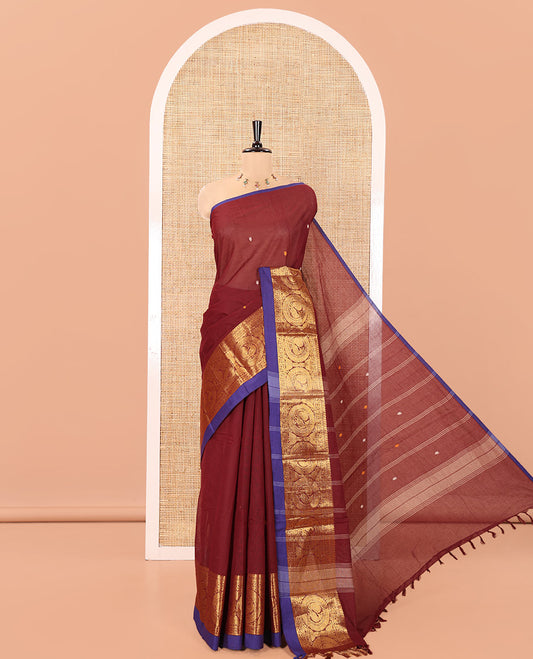 Maroon Chettinad Cotton Saree, Elevated with Thread Buttas All Over Its Body, Highlighted by Traditional Zari Border of Round Peacock Designs, Subtly Striped Pallu, and Paired with a Matching Blouse
